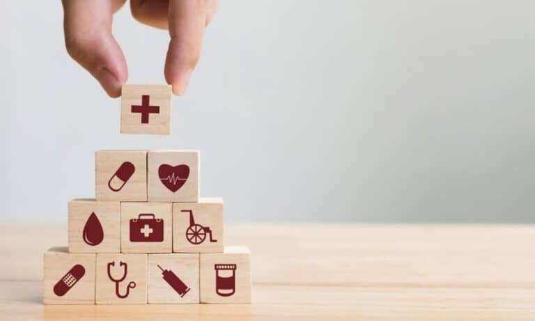 Hand Stacking HR Benefits Puzzle Pieces