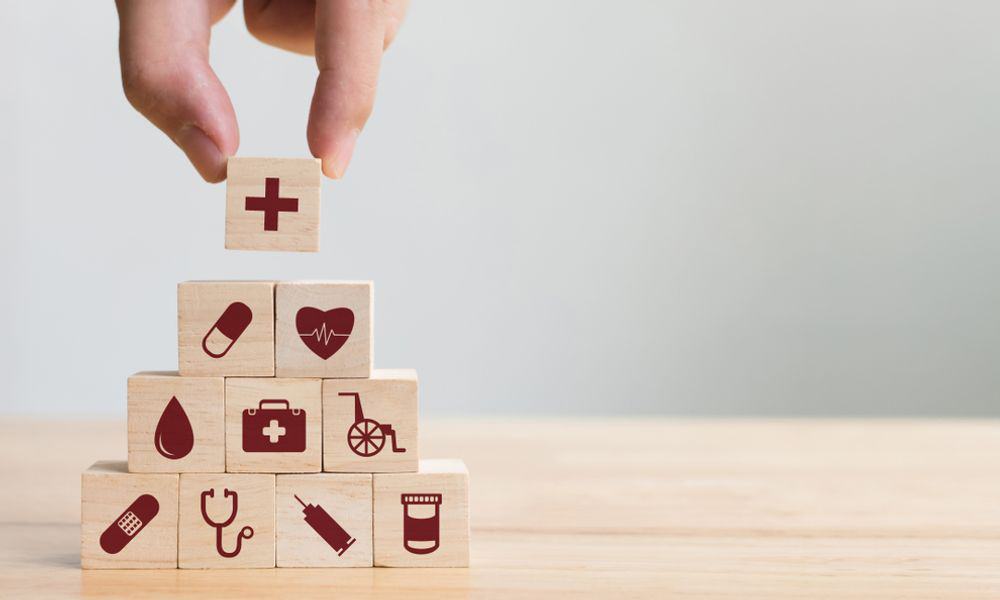 Hand Stacking HR Benefits Puzzle Pieces