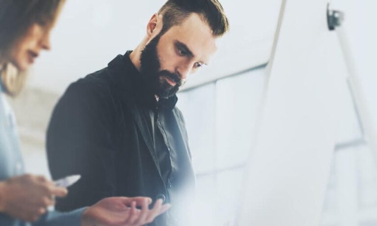 Art Director examines work with colleague