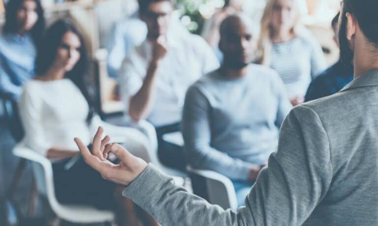 Person gives presentation to crowded room of students