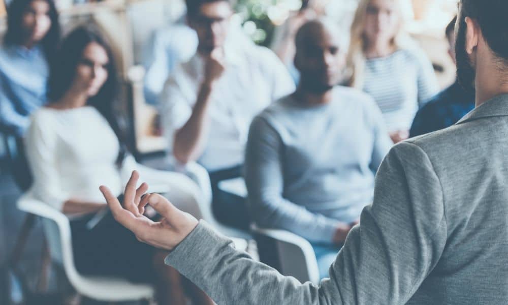 Person gives presentation to crowded room of students