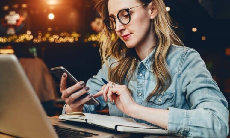 Woman searching on phone while working
