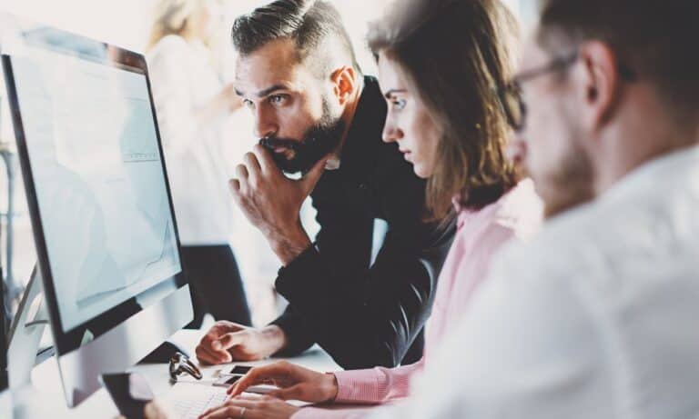 Team looking at website on computer