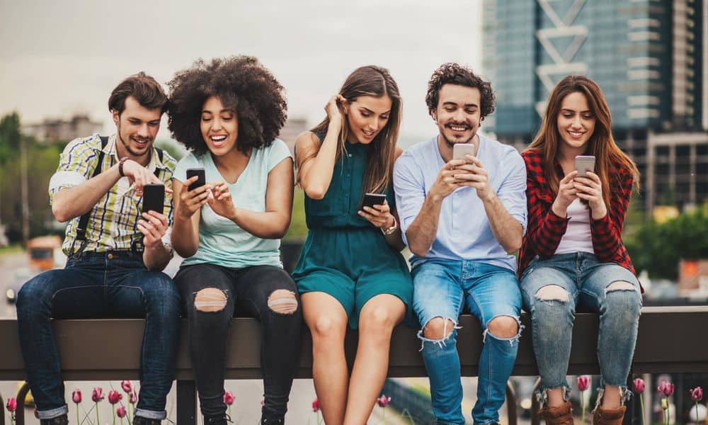 Group of people looking at social media on phones