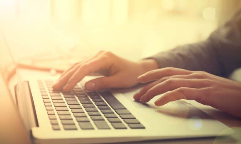 Employee typing on laptop at desk