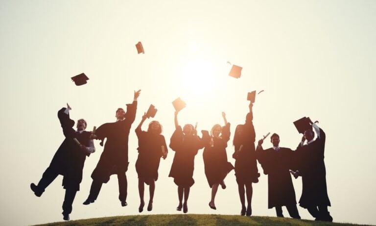 Graduates throw caps at graduation