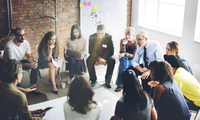 Group of employees sharing opinions in discussion group