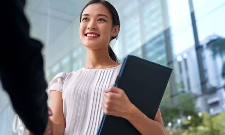Woman shaking hands with potential employer after interview
