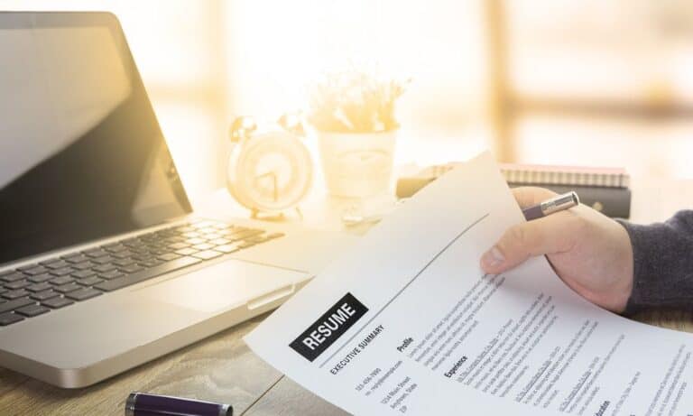 Person reviewing resume at desk
