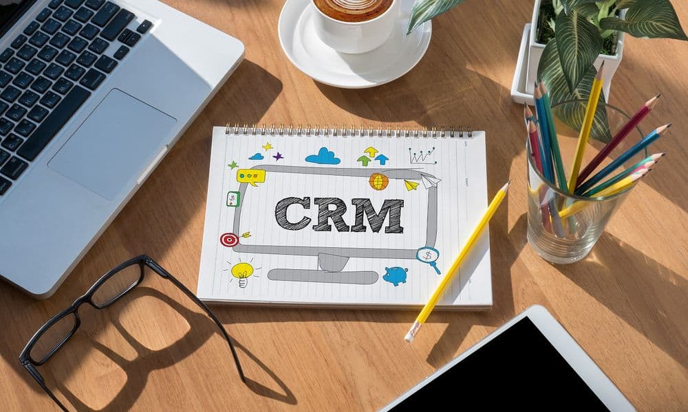 CRM in notebook on desk