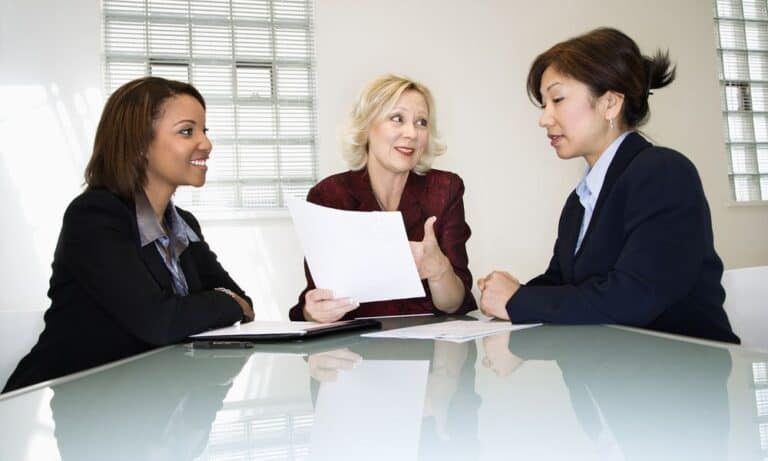Women in meeting around table