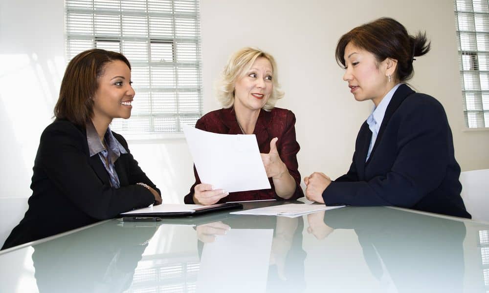 Women in meeting around table