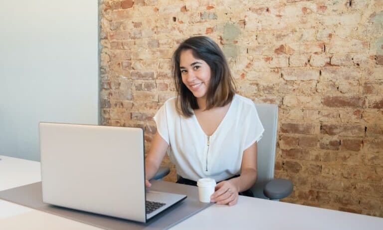 Employee typing at a laptop.