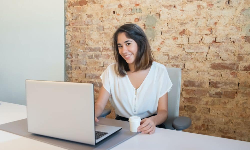 Employee typing at a laptop.