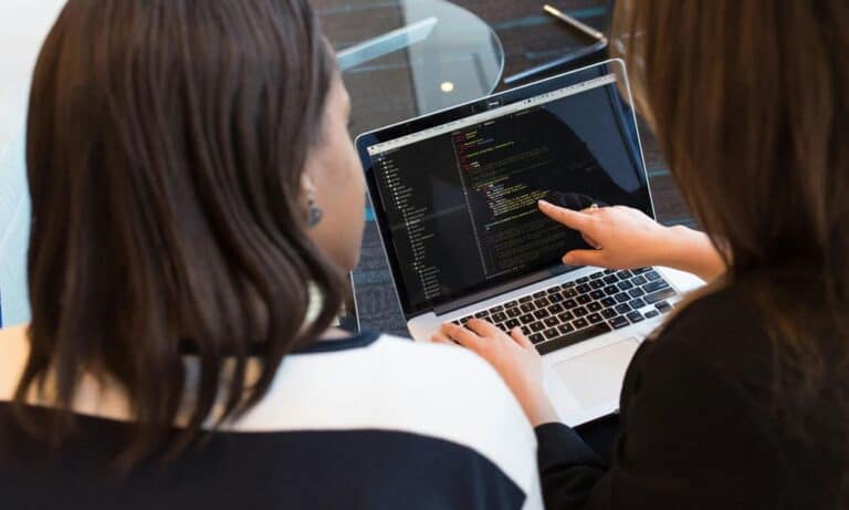 Employee pointing at a laptop.