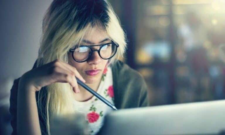 Employee Reviewing Work at Laptop