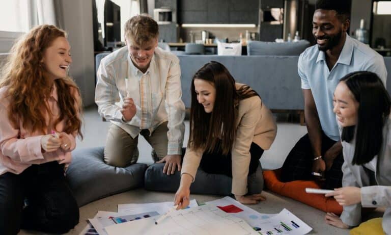 Photo of employees looking over charts together.