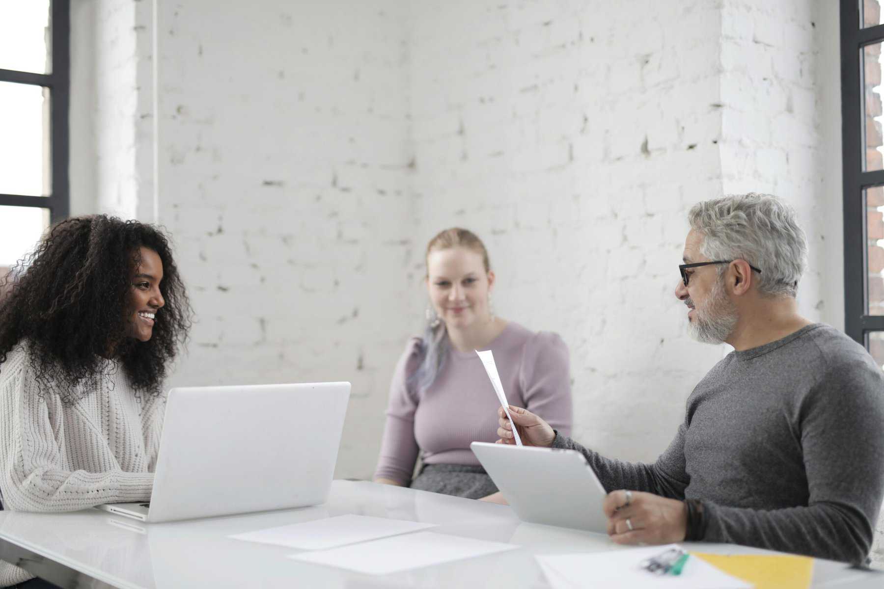 Employees smiling in a meeting.
