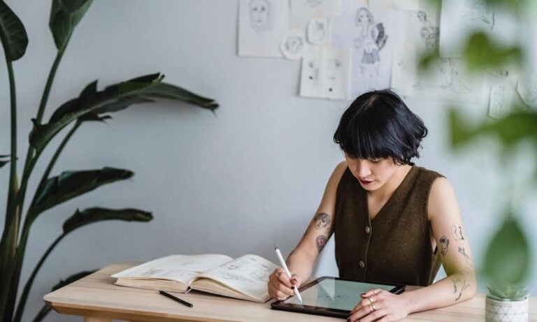 Freelance Graphic Designer using a tablet.