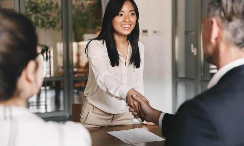 Interviewer shakes hands of potential employer