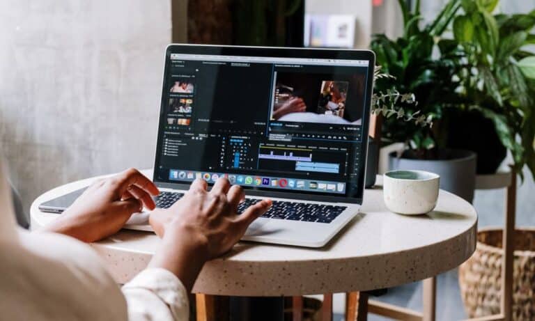 Laptop screen editing video footage.