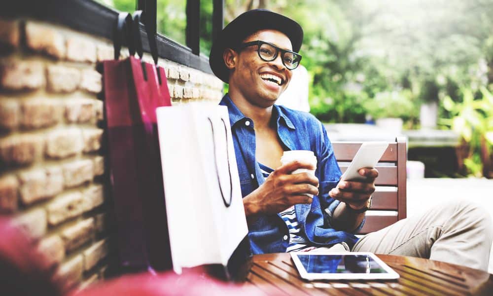 Man relaxing after shopping on his phone