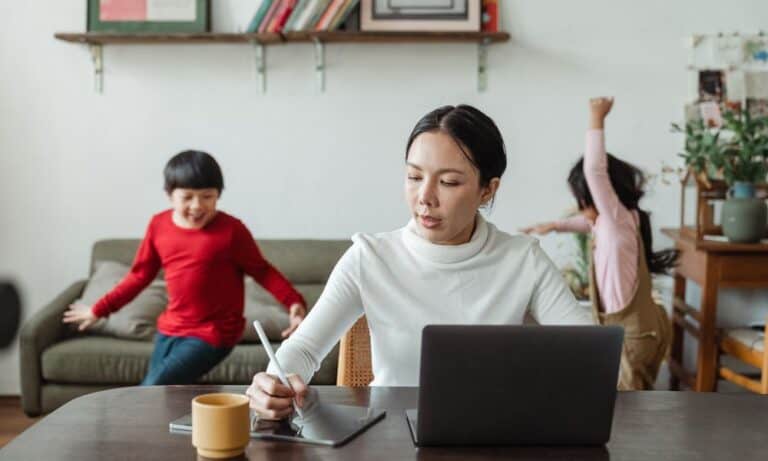 Mom working from home with children.