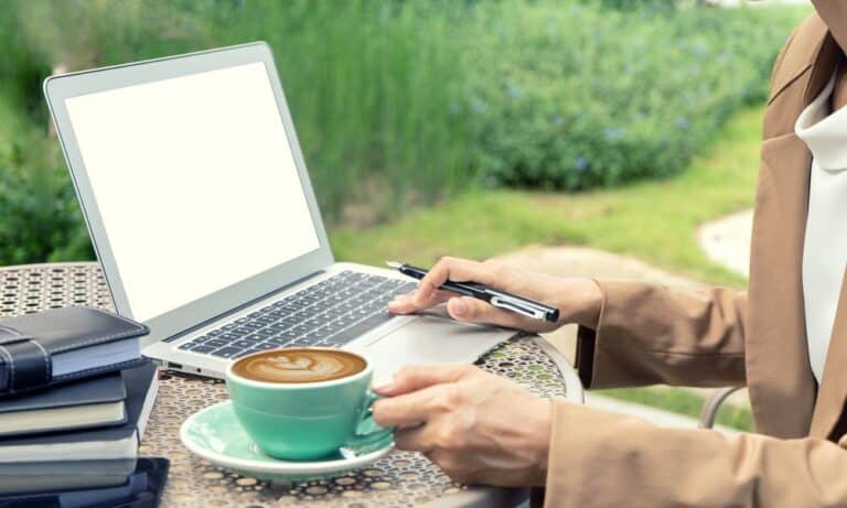 Woman browsing computer drinking coffee