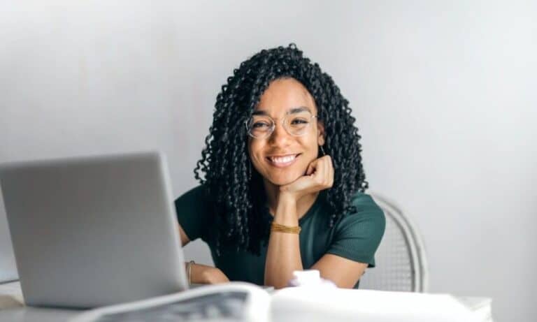 Woman smiling at desk on computer
