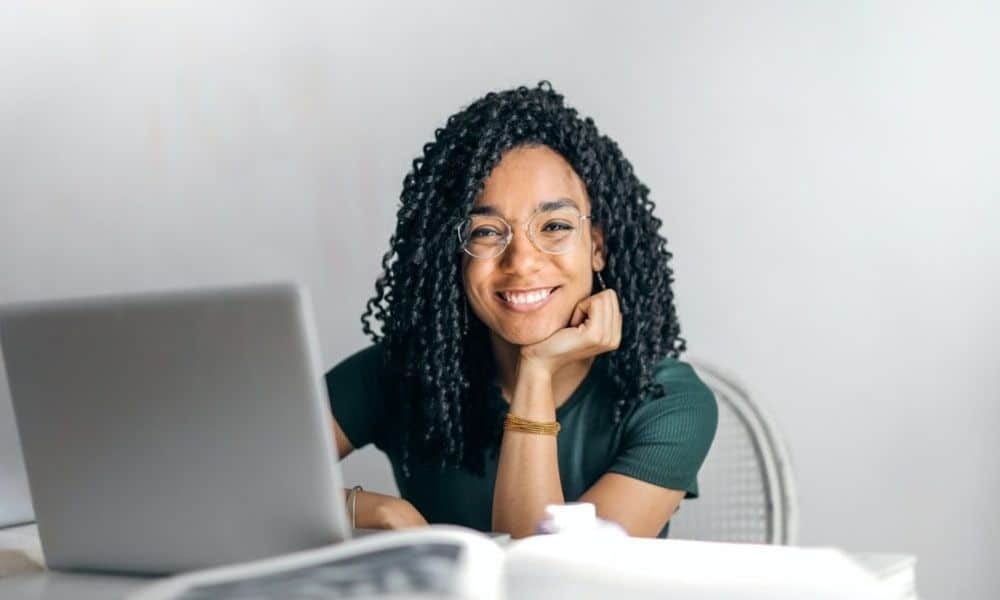Woman smiling at desk on computer