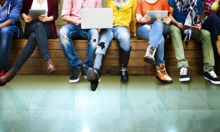 Young Adults Sitting on a Bench