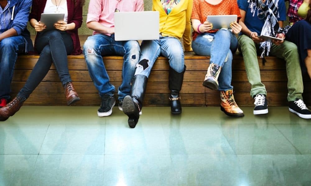 Young Adults Sitting on a Bench