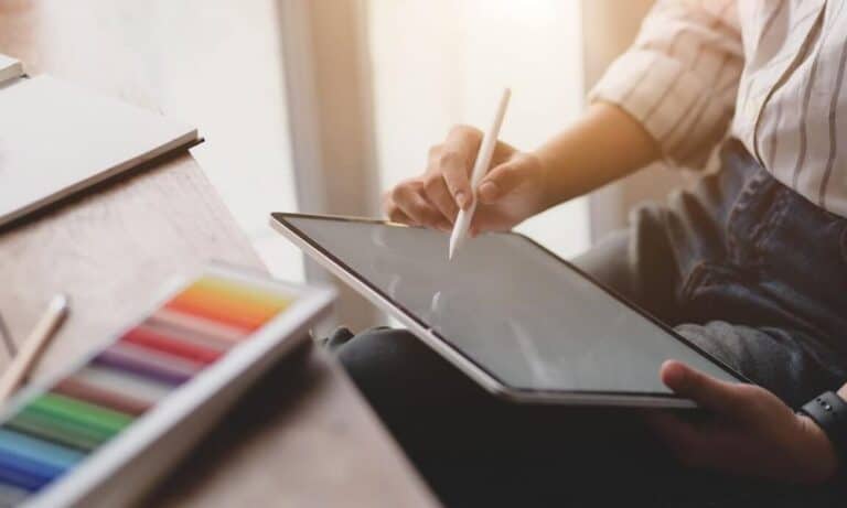 Photo of an art director drawing on an iPad.