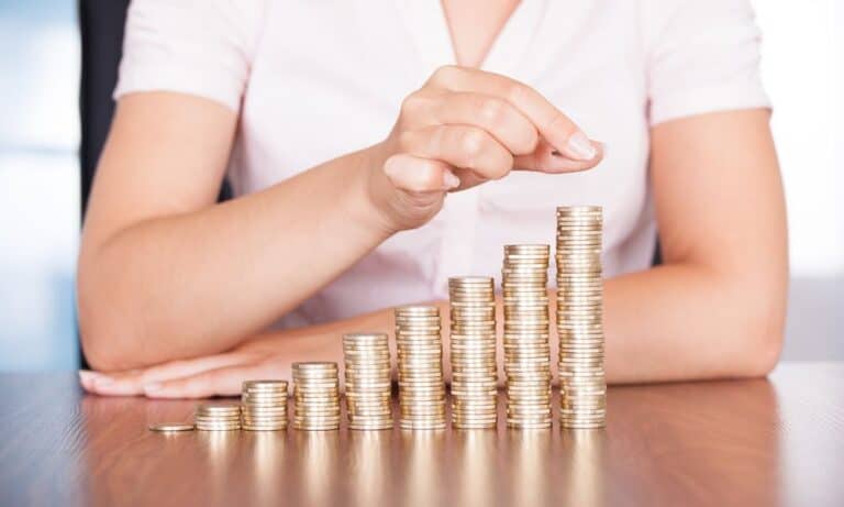 Photo of coins stacked up in a line.