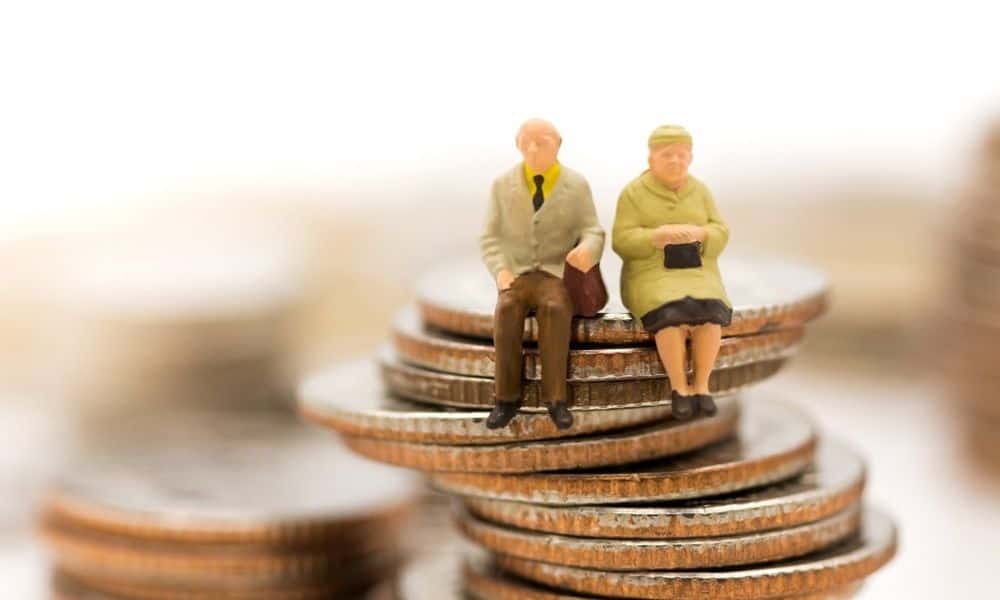 Couple sitting on stack of coins