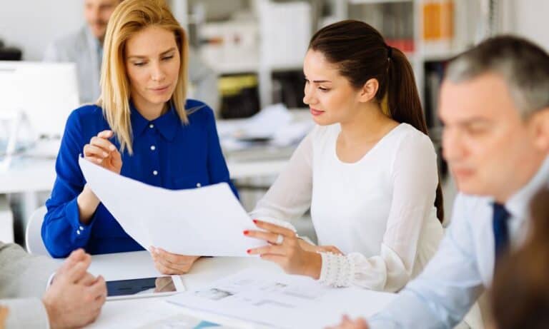 Coworkers discussing project in conference room