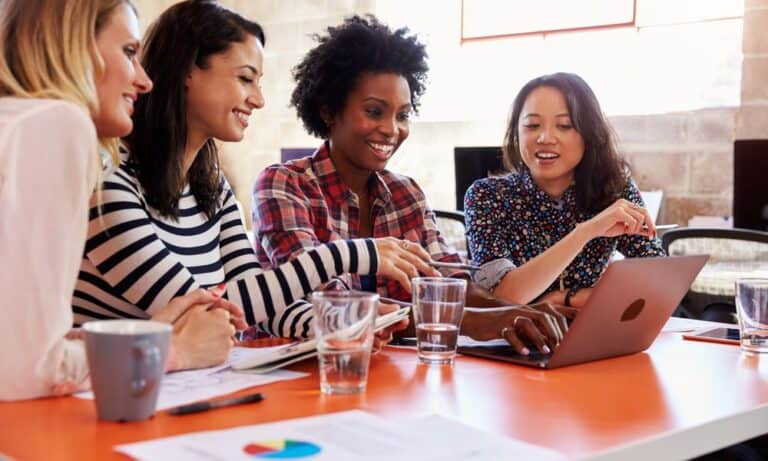 Photo of women working together.