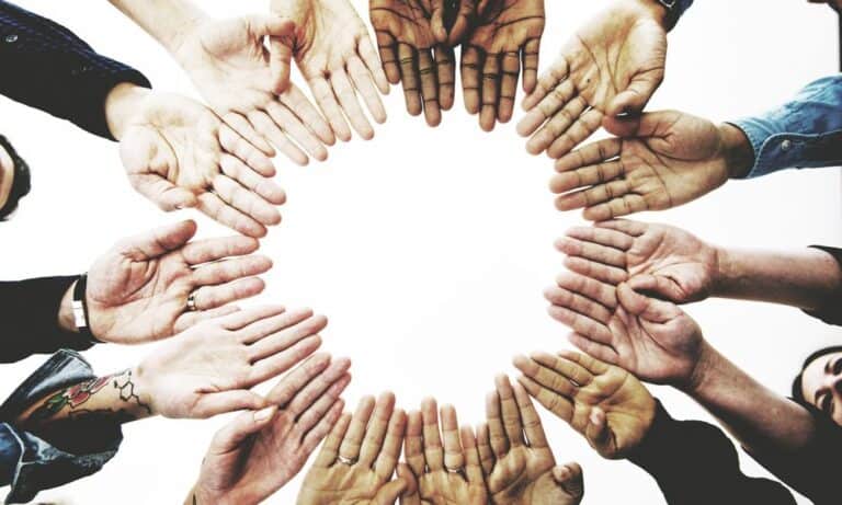 Photo of hands in a circle.