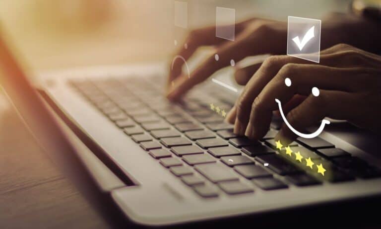 Hands typing on computer writing a review