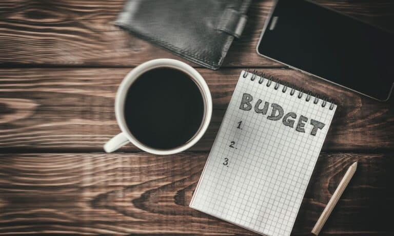Phtoto of managing budget with a cup of coffee.