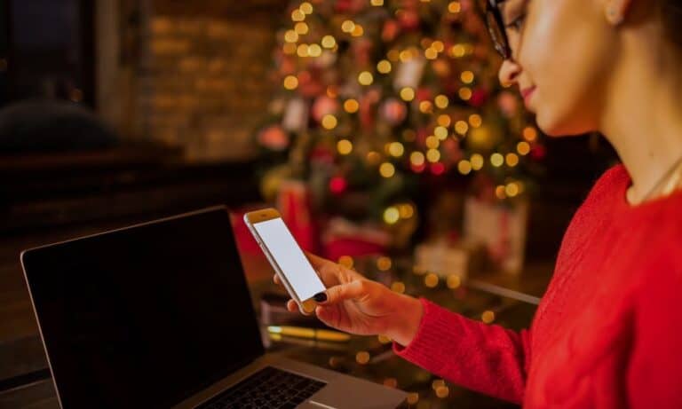 Woman looking on phone during the holidays