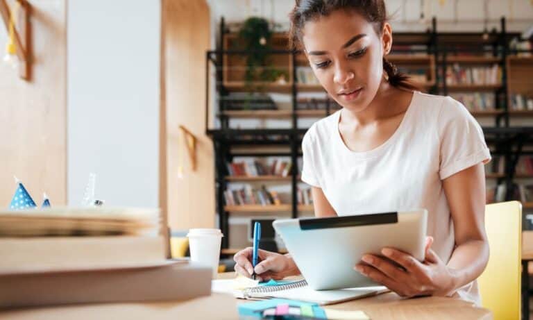 Woman working from iPad at desk