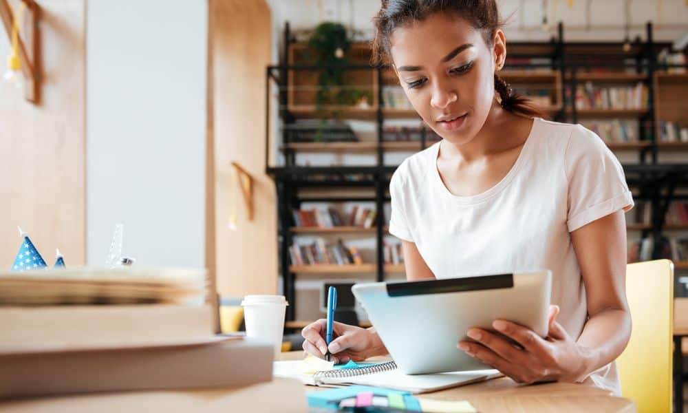 Woman working from iPad at desk