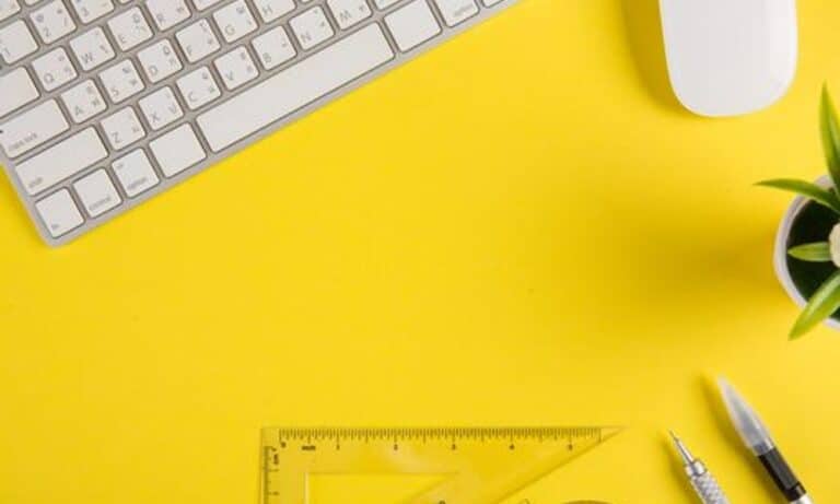 Photo of desk supplies on a yellow background.