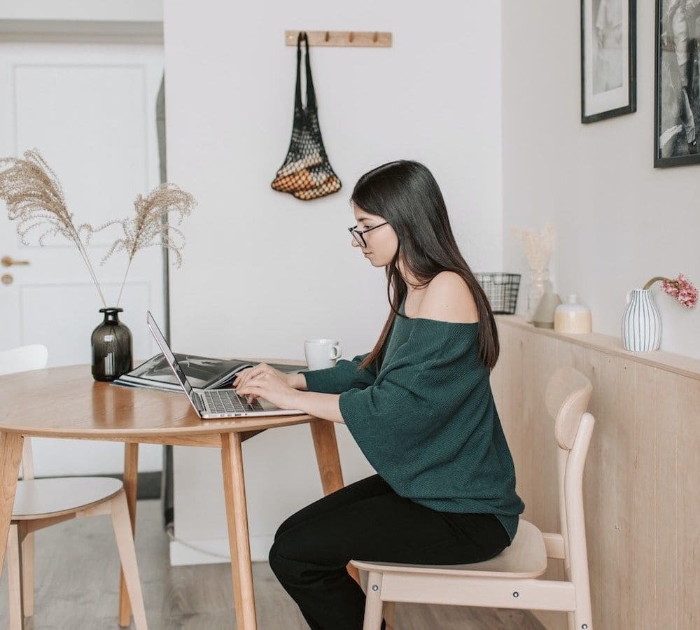 Photo of female marketing professional working on laptop
