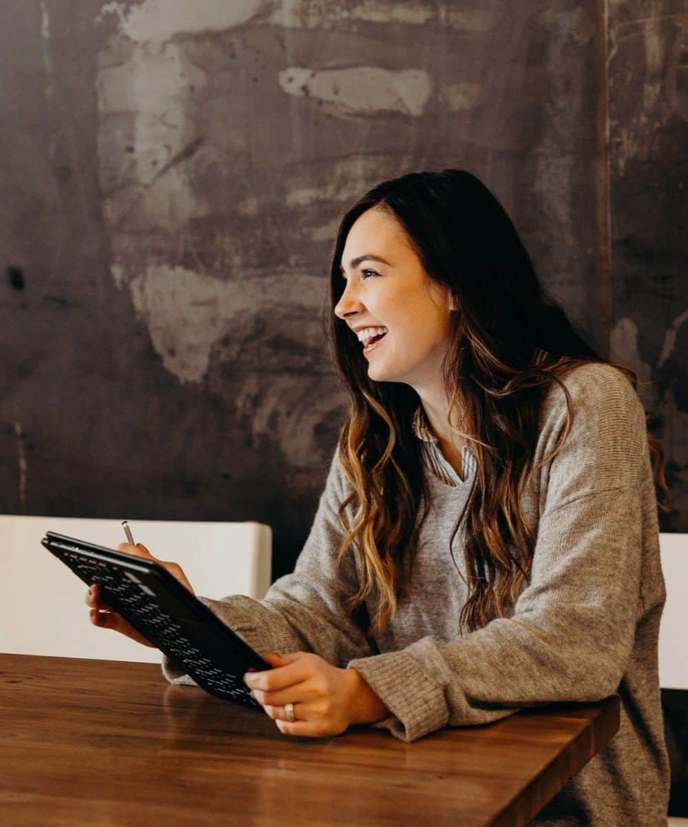 Photo of happy employee working on computer tablet