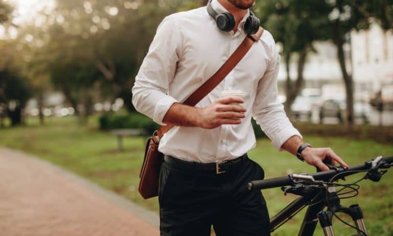 Man with coffee riding bike to work