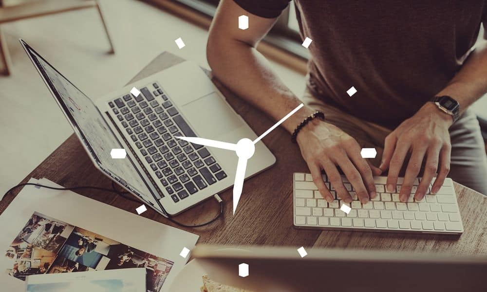 Person working at desk with clock time management