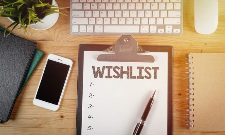 Wishlist written on notebook on desk