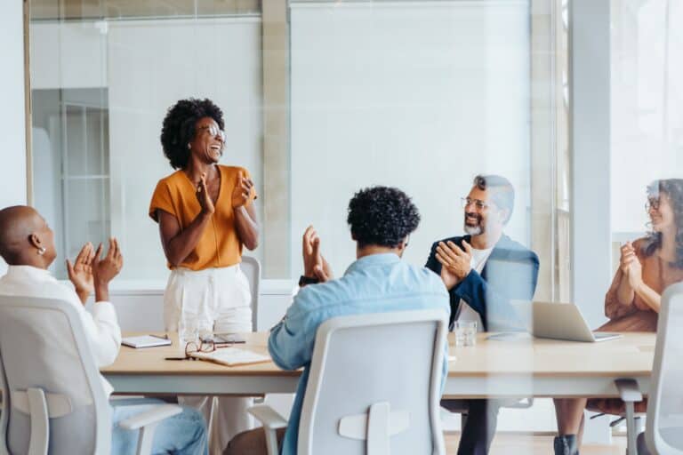 Photo of a team having a successful team meeting.